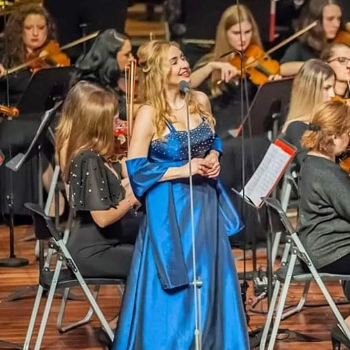 Venicia Rasmussen as orchestra soloist in blue gown